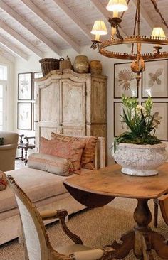 a living room filled with furniture and a potted plant on top of a table