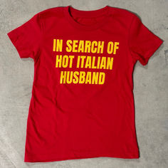 in search of hot italian husband shirt ironic funny unhinged slogan Fun Fitted T-shirt With Text Print, Red Short Sleeve T-shirt With Name Print, Fun Red T-shirt With Name Print, Fitted Tops With Funny Text, Funny Red Tops With Letter Print, Red Funny Tops With Letter Print, Unisex Pre-shrunk Red T-shirt, Fitted Yellow T-shirt With Screen Print, Fitted Red T-shirt With Letter Print