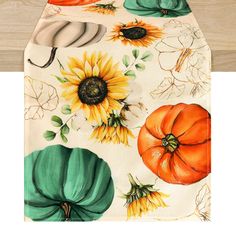 an oven mitt with sunflowers and pumpkins on it