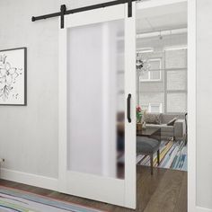 a living room with white walls and sliding glass doors