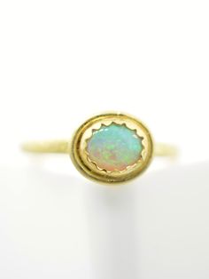 The flash within this beautiful Australian opal from the Lightening Ridge mine is reminiscent of fireflies dancing over a glowing meadow. I love the sparkling blue and green hues of this stone that reveal an incredible rainbow of warm sunrise colours when the light dances over it. One of a kind, this ring features a hand-forged 18k solid gold ring shank and a glowing 22k yellow gold bezel. Materials: Australian Lightening Ridge opal, 18k and 22k yellow gold Size 7.5 This one of a kind ring canno Petal Ring, Sunrise Colors, Ring Shank, Green Hues, Gift Bundles, Solid Gold Rings, Opal Ring, Australian Opal, 22k Gold