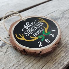 a wooden ornament with the words be merry and reindeer antlers on it