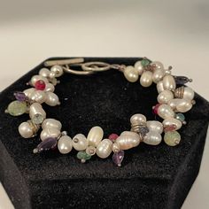 Nwot- Handmade Bracelet With Freshwater Pearls, Rubies, Aquamarine, Apatite, Amethyst, Kyanite And Tourmaline, With A Sterling Silver Toggle Clasp. 7.5 Inches Long. All Natural Stones, New Bracelet White Pearl Bracelet With Oyster Design In Sterling Silver, Handmade White Pearl Bracelet For Jewelry Making, Unique Hand-strung White Jewelry, Unique White Hand-strung Jewelry, White Sterling Silver Hand-strung Jewelry, White Sterling Silver Bracelets, White Pearl Bracelet With Natural Stones, Unique White Sterling Silver Bracelets, Elegant White Beaded Bracelets With Gemstones