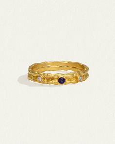 a gold ring with blue sapphire stones