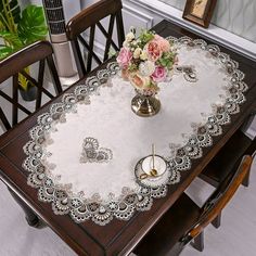 a table with flowers and candles on it