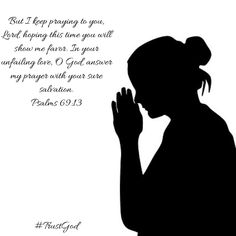 the silhouette of a woman praying with her hands clasped to her chest, in front of a