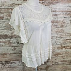 American Rag Egret White Lace Trim Flutter Blouse L Nwt 005623-B21 Egret White Round Neck Short Flutter Sleeves Pleat Details Illusion Neckline Lace Panels Crochet Trim Tie At Back Of Waist Button Loop Closure At Back Of Neck Measurements In Photoset Juniors Large Elegant Flutter Sleeve Blouse For Day Out, White Blouse With Ruffles And Flutter Sleeves, Flowy Butterfly Sleeve Summer Blouse, Flowy Butterfly Sleeve Blouse For Summer, Elegant Flowy Top With Flutter Sleeves, Feminine Off White Short Sleeve Top, Feminine Off-white Short Sleeve Tops, White Ruffled Butterfly Sleeve Top, White Ruffled Top With Butterfly Sleeves