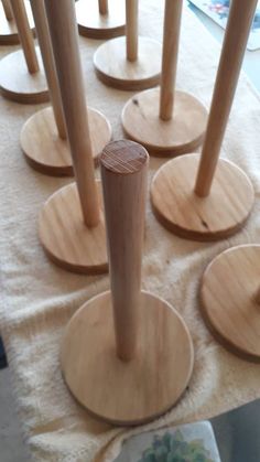 several wooden poles are arranged in rows on a table with plates and utensils