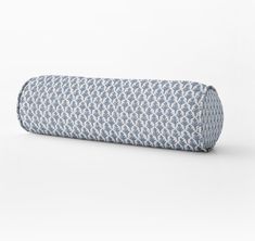 a blue and white patterned pillow on a white background with the bottom rolled up to look like an eyeglass case