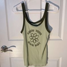 Green Tank Top From American Eagle. Size Medium. Never Worn. “Grow Your Own Way” Printed On The Front. Retro Green Tank Top For Spring, Vintage Spring Letter Print Tank Top, Green Fitted Camisole Tank Top, Green Retro Cotton Tank Top, Retro Green Cotton Tank Top, Green Bohemian Cami Tank Top, Bohemian Green Cami Tank Top, Green Cotton Y2k Tank Top, Green Cotton Graphic Print Tank Top