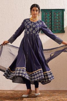 Navy blue long sleeves panelled anarkali in chanderi base with block printed yoke, border, gold detailing on kalis and gota stripes on the cuffs. Paired with churidaar and organza dupatta with gold and same coloured lace.
Components: 3
Pattern: Print
Type Of Work: Floral Block
Neckline: Round
Sleeve Type: Long
Fabric: Chanderi
Color: Blue
Other Details: 
Attached inner lining
Model Height: 5ft 4inches, wearing size S
Occasion: Puja, Mehendi and Haldi - Aza Fashions Indigo Long Sleeve Set For Festive Occasions, Long Sleeve Anarkali Set With Mirror Work For Festivals, Eid Long Sleeve Salwar Kameez With Gota Work, Eid Salwar Kameez With Gota Work And Long Sleeves, Festival Long Sleeve Anarkali Set With Mirror Work, Festival Long Sleeve Anarkali With Mirror Work, Indigo Long Sleeve Sets For Designer Wear, Long Sleeve Salwar Kameez With Cutdana For Festivals, Long Sleeve Cutdana Salwar Kameez For Festivals