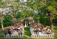 an outdoor wedding ceremony in the woods