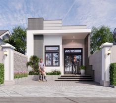 two people standing in front of a house with stairs and plants on either side of the entrance