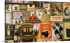 a wall covered with lots of different types of beer signs and magnets on it