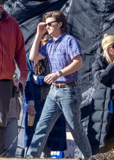 a man walking down the street while talking on a cell phone