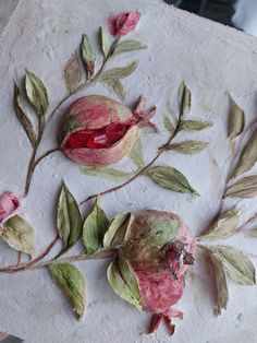 two pieces of paper with flowers and leaves on them