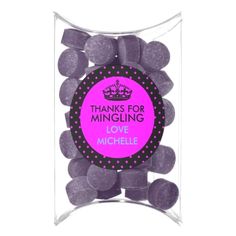 a bag filled with lots of chocolate candies in purple and black polka dot print