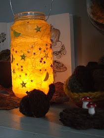 a mason jar filled with yellow stars on top of a shelf next to other items