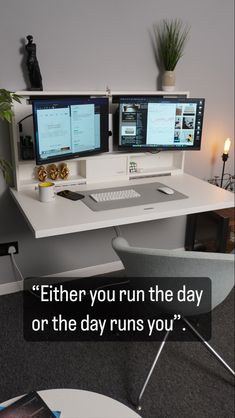 two computer monitors sitting on top of a white desk