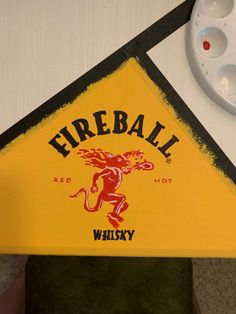 there is a yellow and black fireball sign on the wall