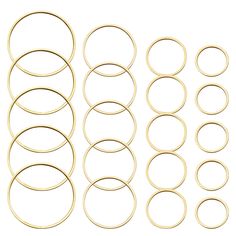 an assortment of gold colored metal rings on a white background with clippings for text