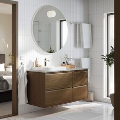 a bathroom with a sink, mirror and bathtub in the middle of the room