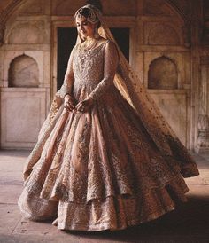 a woman in a pink and gold wedding gown