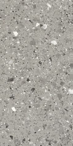 an asphalt surface with white and black dots on it, as well as small rocks