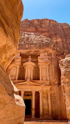 an ancient building carved into the side of a cliff