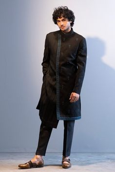 Black achkan style sherwani with floral embroidered motifs, highlighted with dabka work and pintuck asymmetric panel. Paired with pant.
Component: 2
Embroidered
Neckline: Band
Sleeve Length: Full
Fabric: Slub Silk, Cotton Silk
Color: Black
Asymmetric panel - Aza Fashions Embroidered Fitted Sherwani For Semi-formal Occasions, Fitted Black Sherwani With Naqshi, Fitted Black Sherwani With Naqshi Detail, Designer Fitted Sherwani For Ceremonial Occasions, Fitted Kurta With Zari Work For Semi-formal Occasions, Designer Sherwani With Resham Embroidery, Fitted Resham Embroidery Kurta For Semi-formal Occasions, Designer Bandhgala With Intricate Embroidery, Designer Traditional Wear With Dabka For Winter