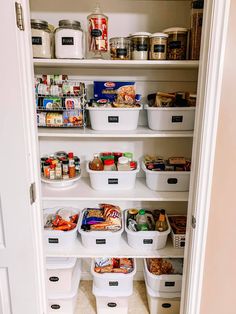 an organized pantry with white bins filled with food