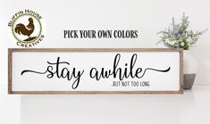 a wooden sign that says stay awhile, but not too long on the wall next to a potted plant