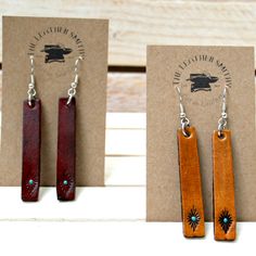 the earrings are made from wood and have turquoise stones on them, along with a card