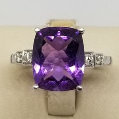 "Vintage 14K White Gold Amethyst & Diamonds Ring, Size 8.5. Stamped HOU with a smaller u inside the O & 14K inside band. Weighs 2.9 dwt. We do not check prongs for wear or stones for looseness. All items are sold as is-noting that we are a resale shop so everything here had a previous owner! We will include flaws in the description when noted. This is one of the reasons our items are more affordable than new at a jewelry store. Are these stones real or fake? Aside from diamonds, we do no Luxury Amethyst Cushion Cut Ring For Formal Occasions, Luxury Amethyst Cushion Cut Ring For Formal Events, Luxury Cushion Cut Amethyst Ring For Formal Occasions, Formal Amethyst Diamond Ring With Gemstone Accents, Formal Amethyst Rings With Diamond Accents, Luxury Purple Diamond-cut Jewelry, Formal Purple Amethyst Ring With Diamond Accents, Luxury Round Cut Amethyst Gemstones, Fine Jewelry Purple Rings With Diamond Accents