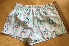 "Horses/Horseshoe theme on green and white striped background flannel sleep shorts 100% cotton flannel Enclosed elastic waistband with 1/2\" non-roll elastic Low rise Side seams 2\" inseam on all sizes Hip sizing: XS(32-34\"), S(35-37\"), M(38-40\"), L(41-43\") Front rise: XS(9 3/4\"), S(10 1/2\"), M(11 1/2\"), L(12 3/4\") Back rise: XS(13 1/2\"), S(14 1/2\"), M(16\"), L(16 3/4\") Measurements are approximate Sizing allows for about 2-3 inches of ease/shorts run a size smaller than the pants All Cute Cotton Pajama Shorts With Relaxed Fit, Green Relaxed Fit Cotton Pajama Shorts, Cute Cotton Sleepwear Short Length, Cute Cotton Short Sleepwear, Green Spring Sleep Bottoms, Green Pajama Shorts For Summer Sleepover, Green Cotton Pajama Shorts With Elastic Waistband, Cute Green Cotton Sleepwear, Green Cotton Pajama Shorts