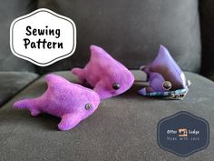 two purple stuffed animals sitting on top of a gray couch next to each other with the words sewing pattern above them