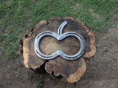 an apple shaped object sitting on top of a tree stump