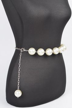 Elevate your outfit with our Iconic Pearl Station Chain Belt. Indulge in the luxury of genuine pearls and a delicate chain, adding a touch of elegance to any look. Complete your wardrobe with this timeless and sophisticated accessory. One Size Width - 1.25" Length - 50" PVC, Faux Pearl, Mix Metal Lead & Nickel Compliant Classic Pearl Necklace With Pearl Chain For Parties, Classic Pearl Necklace For Party, Chic Adjustable Pearl Necklace, Formal Pearl Necklace With Chain, Trendy Pearl Necklace With Beaded Chain, Pearl White Party Jewelry With Chain, Adjustable Pearl Necklace With Chain, Chic Silver Pearl Necklace With Adjustable Chain, Trendy Beaded Chain Pearl Necklace For Party