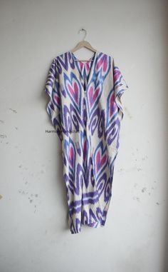 This Cotton ikkat Kaftan Is made From incredibly soft and lightweight cotton and is versatile for many occasions. It is so free flowing that it will make you feel as you are not wearing anything at all. The beauty of Front open kaftan is that they will fit everyone. You can wear it as a kaftan and kimono also.  The perfect floral print Kaftan is used to Lounge Wear, Resort Wear, Party Dress, beach Cover up, House Working Dress and use for a dinner party or just slip into in on a beautiful summer Traditional Ikat Print Maxi Kaftan, Long Patterned Kaftan For Festival, Traditional Maxi Kaftan With Ikat Print, Multicolor V-neck Kaftan With Batik Print, Bohemian Long Kimono With Ikat Print, Long Bohemian Kimono With Ikat Print, Traditional Ikat Print Tunic Kaftan, Summer Multicolor Ikat Print Kimono, Bohemian Kaftan With Ikat Print And Kimono Sleeves