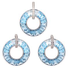 18k white gold baguette-cut blue topaz diamond circle pendant earrings set. This exquisite 18k white gold blue topaz diamond circle set—a radiant ensemble crafted to elevate your style with its captivating beauty. Meticulously fashioned in luxurious 18-karat gold, this set features a stunning circle adorned with mesmerizing blue topaz gemstones set from dark to light along sparkling diamonds. At the heart of each piece, the serene blue hues of swiss blue topaz, sky blue topaz and london blue topaz gemstones evoke a sense of tranquility and elegance. Surrounding the blue topaz, pave-set diamonds grace the loop of both the pendant and earrings, adding a touch of celestial sparkle and refinement to the design. Note: The chain shown with the pendant is not part of the set. Metal Type: 18K Whit Pendant Earrings Set, Diamond Circle Pendant, Life Jewelry, Circle Diamond, Sky Blue Topaz, Diamond Settings, Swiss Blue Topaz, London Blue Topaz, Topaz Gemstone