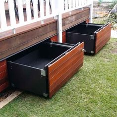 two wooden planters sitting next to each other on the grass