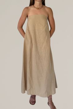 this linen strapless column dress is a must have for your summer wardrobe. crafted from a luxurious linen blend, this maxi dress offers a perfect combination of comfort and elegance. the strapless design and flowing silhouette create a chic and effortless look, ideal for warm weather occasions. whether you're heading to a beach party or a casual brunch, this versatile dress will keep you cool and stylish all day long. 80% linen | 20% viscose gentle wash cold | lay flat to dry | do not iron model Solid Linen Maxi Dress For Vacation, Summer Maxi Dress With Straight Neckline, Casual Maxi Dress With Straight Neckline, Elegant Linen Maxi Dress, Solid Color Maxi Dress With Straight Neckline For Summer, Strapless Linen Dress For Spring, Elegant Beige Linen Maxi Dress, Solid Maxi Dress With Straight Neckline For Summer, Elegant Beach Maxi Dress With Straight Neckline