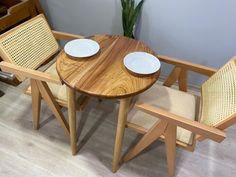 two chairs and a table with plates on them