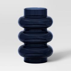 a blue vase sitting on top of a white table