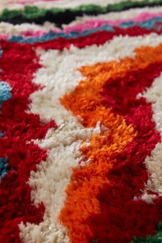 a multicolored area rug with an interesting design