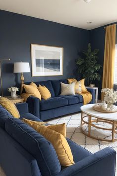 a living room filled with blue couches and yellow throw pillows on top of a rug