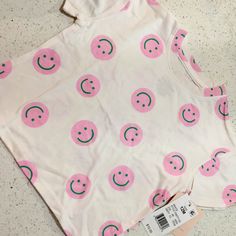 Pink Smiley Printed Cute Pink T-shirt With Graphic Print, Playful Pink T-shirt For Spring, Playful Pink Short Sleeve T-shirt, Pink Cotton T-shirt For Summer, Trendy Cotton T-shirt For Playwear, Playful Pink Tops With Letter Print, Pink Printed Short Sleeve T-shirt, Cute Pink T-shirt With Funny Print, Cute Pink T-shirt With Cartoon Print