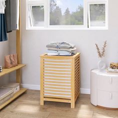 a clothes rack in the corner of a room next to a window with white curtains