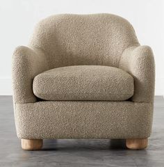 a beige chair sitting on top of a hard wood floor