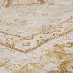 an area rug is shown with gold and white colors on the carpet, including brown accents